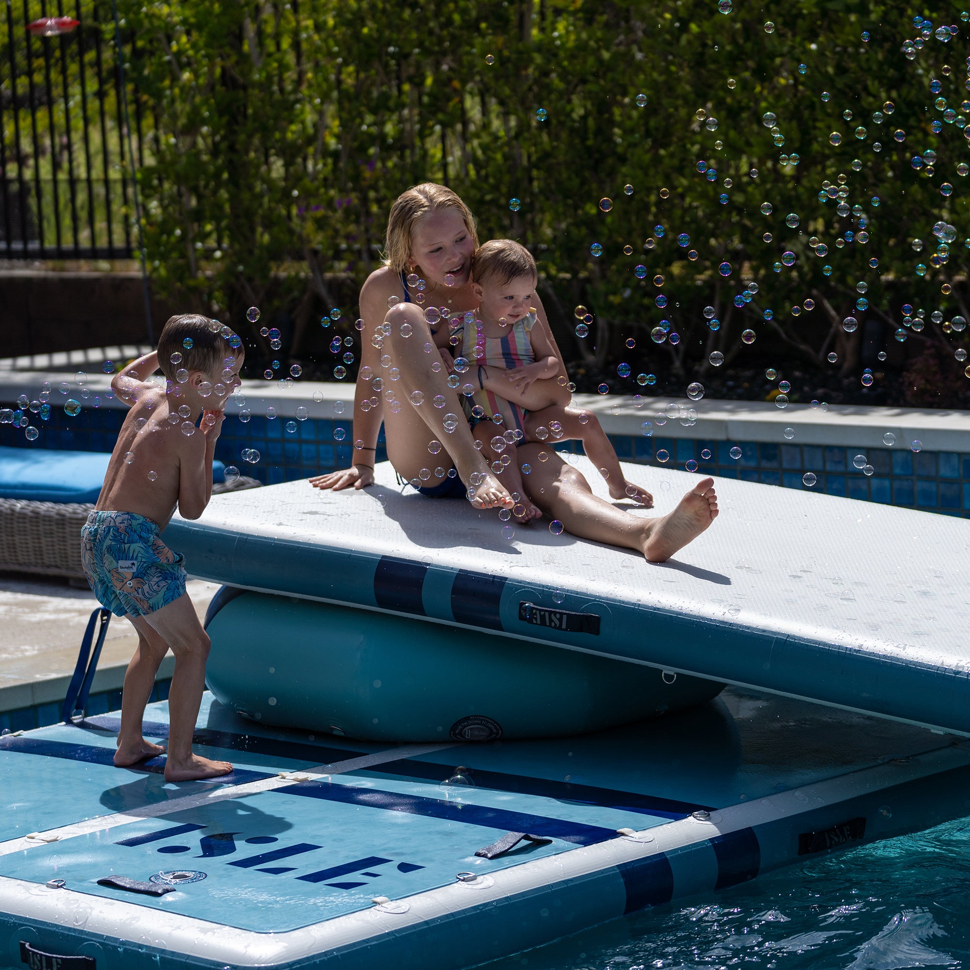 Kids Sliding On The Runway Dock & Air Track in a Pool