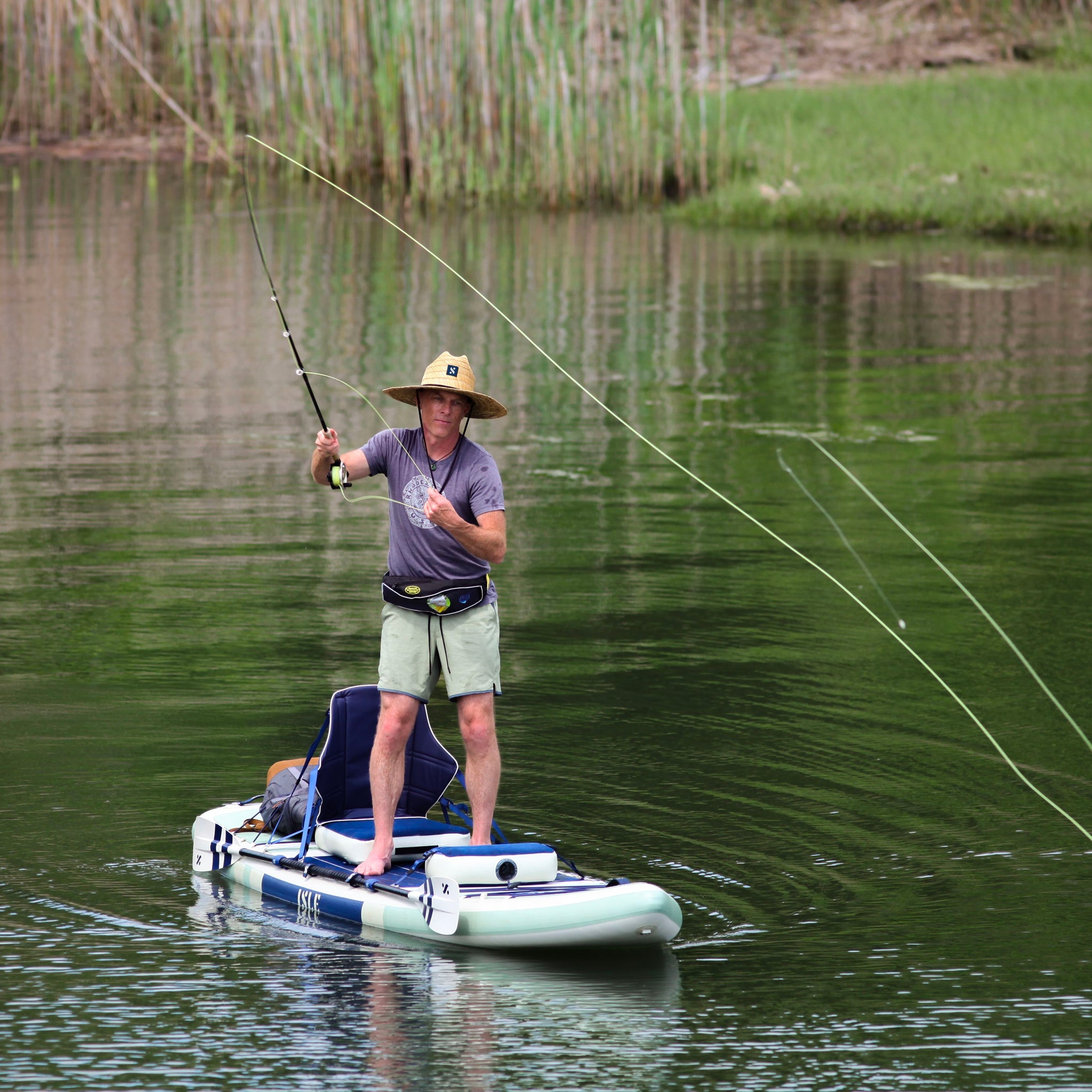 Man Fishing On A Paddle Board