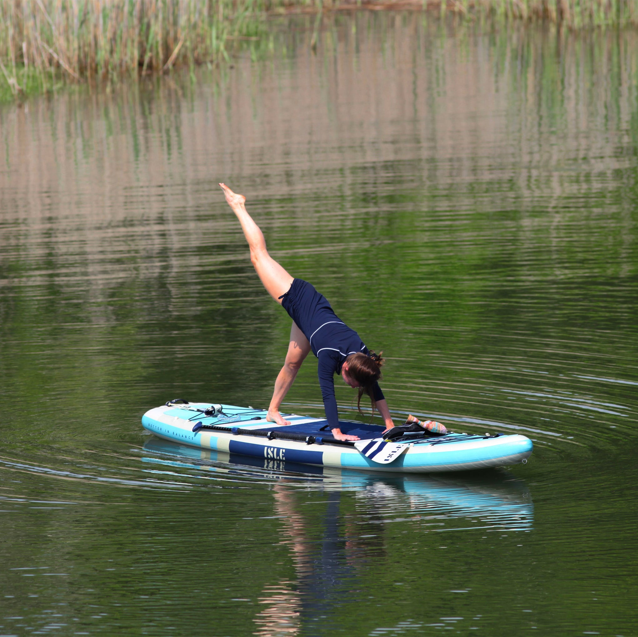 Woman Doing Yoga Pose On A Paddle Board