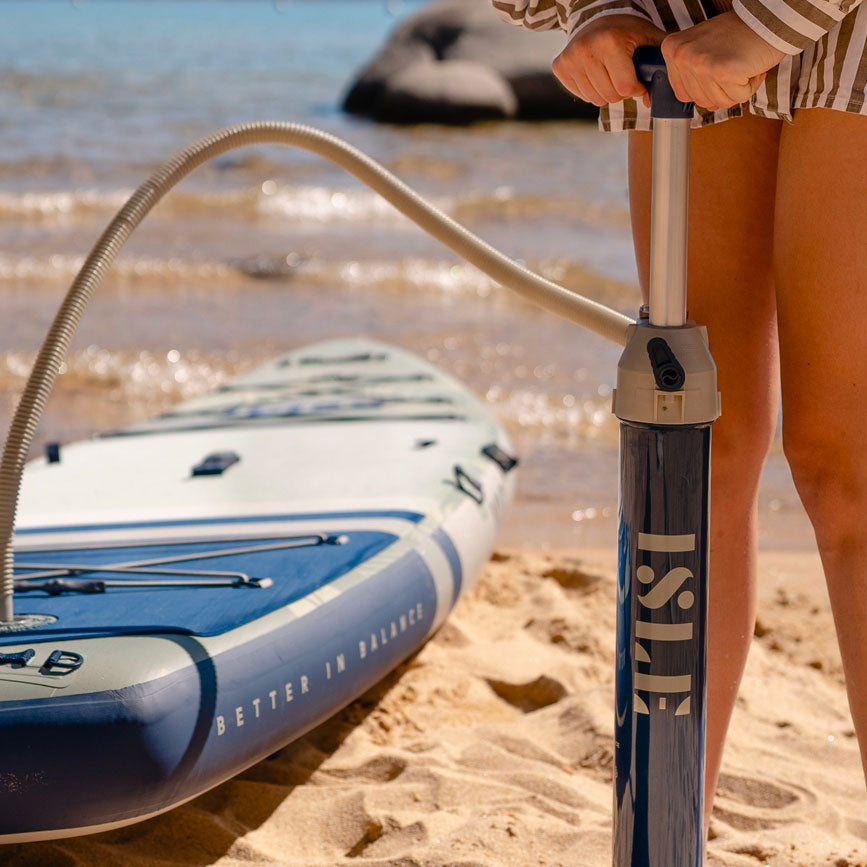 Slim Hand Pump Being Used To Inflate A Paddle Board