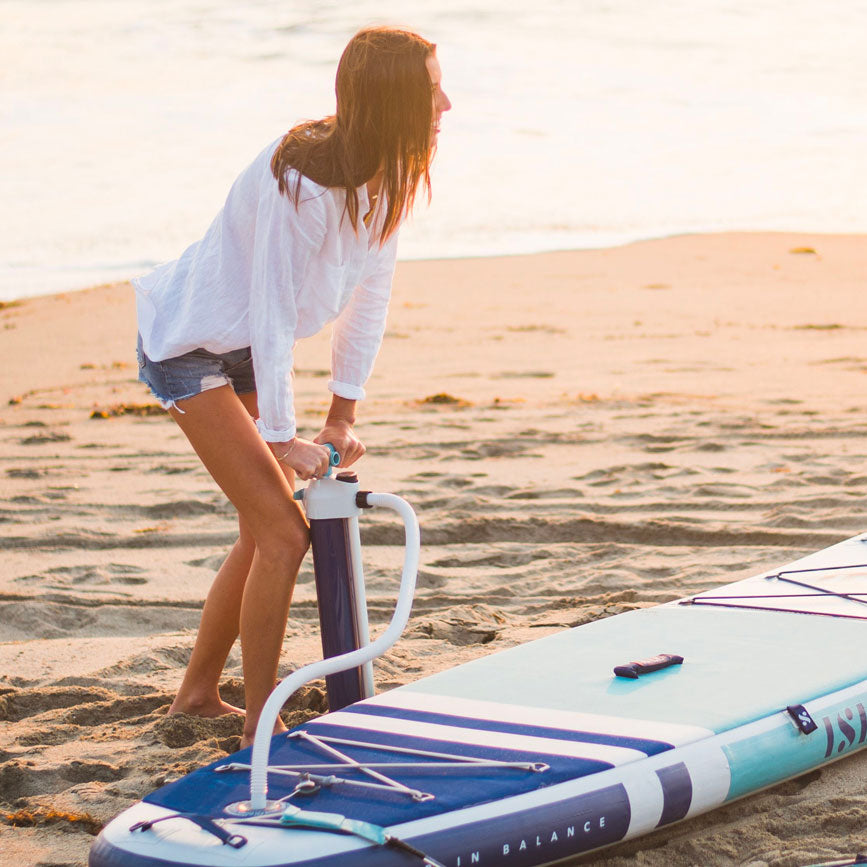 Women Inflating a Paddle Board Using A Hand Pump