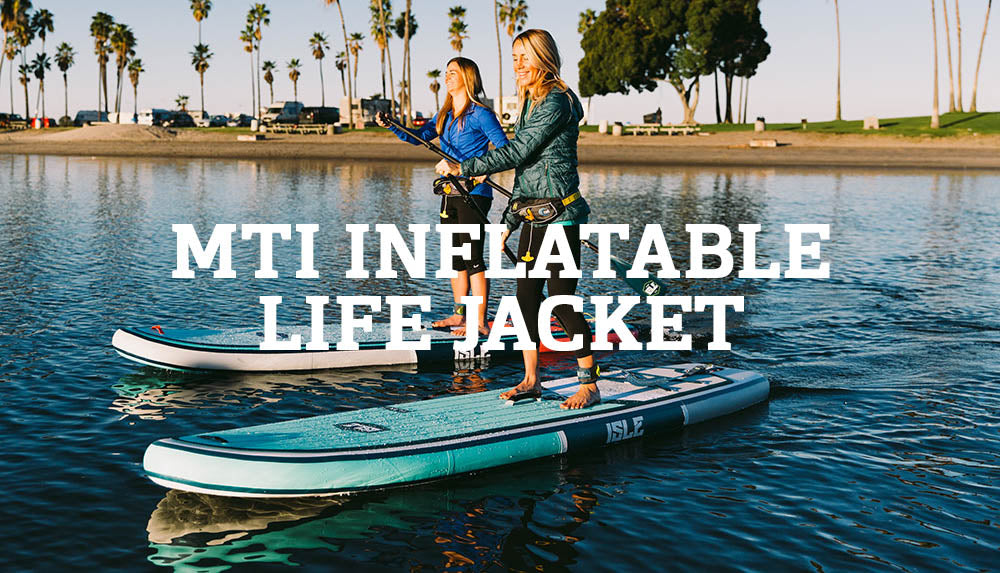 Two Women Wearing The MTI Fluid 2.0 Inflatable Belt Pack Life Jacket While Paddle Boarding