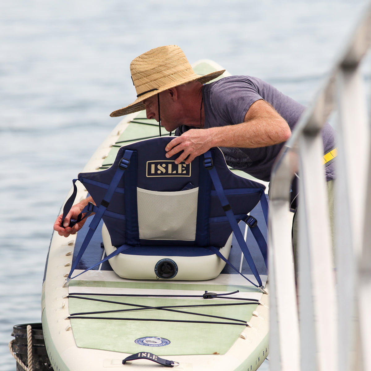 Man Putting A Cloud Kayak Seat Onto a Paddle Board